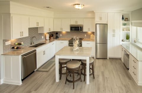 Fully equipped kitchen, dining with seating for 4, desk with chair, marina view