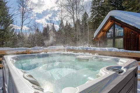 Relax in the hot tub and take in the mountain views