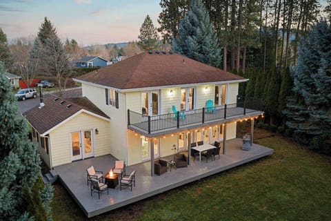 Private backyard retreat with expansive covered decks, fire pit, and forest views — designed for gathering, relaxing, and long summer nights.