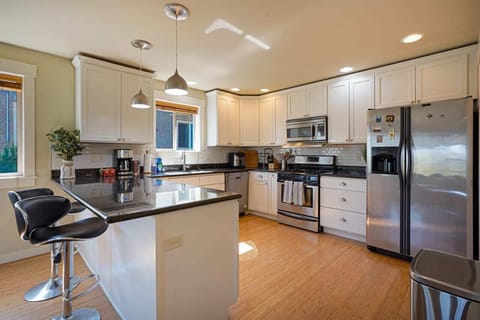 Indulge your culinary passions in the spacious, fully-equipped chef's kitchen, featuring a breakfast bar for two