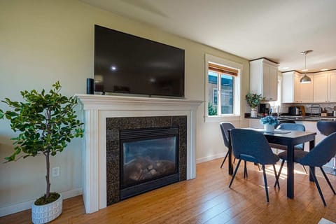 The fireplace, thoughtfully nestled by the dining area, adds warmth and charm to every gathering