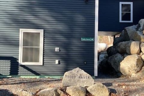 Park Alongside the Toddy Haven rock and entrance is in the pathway along rock wall to the right.