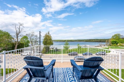 Located just off of the upstairs primary bedroom, the upper deck offers stunning water views.