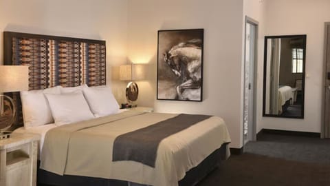 Recharge in a calming bedroom with artful accents and soft lamps.