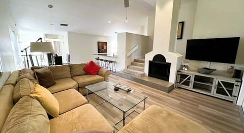 Relax on the spacious sectional with a fireplace, TV, and easy access to the home's main living areas