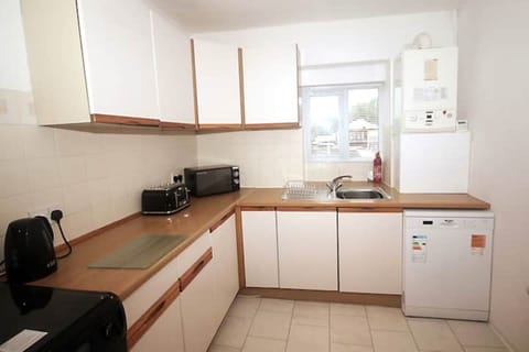 Kitchen with oven, grill, hob, kettle, toaster, microwave, dishwasher, fridge