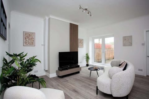 Welcome to your urban oasis in the heart of the city! Step into the spacious living room where modern elegance meets comfort!!