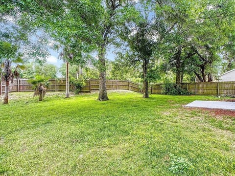 Fully fenced yard under the oaks