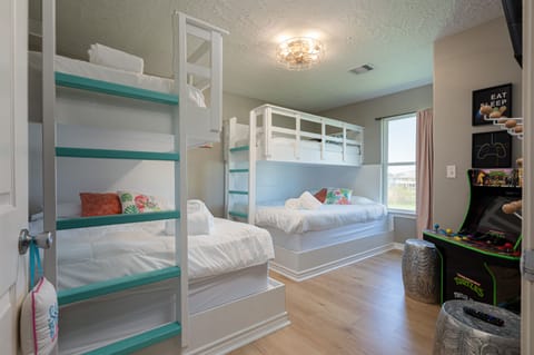 Bunk room sleeps 6 and has an arcade game and TV