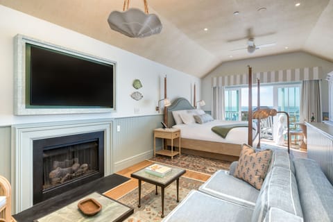 Gather fireside in a sun-kissed living space where casual elegance and coastal comfort come together.