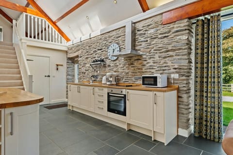 Kitchen cabinets against the wall with oven and microwave in the kitchen