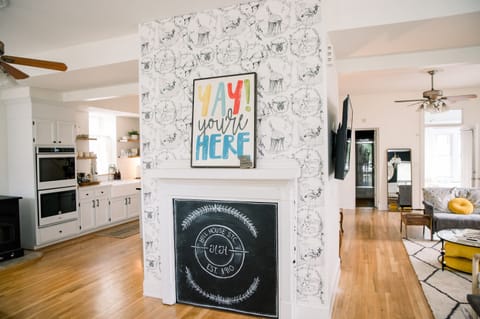 Entry with chalkboard – Welcoming central hearth with chalkboard art and playful “YAY you’re here” sign sets the tone for a memorable stay 🔥✨
