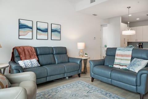 Cozy living room w/ plush seating, soft accents & a relaxed setup for unwinding together.