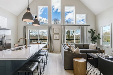 Professionally designed, open-space living room, kitchen, and dining area with a large, walk-out upper deck