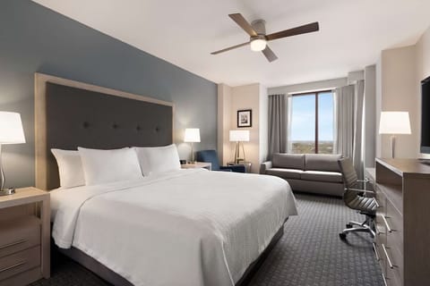 Settle into a spacious king bed with relaxing skyline views.