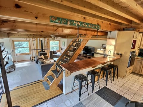 Entryway of the Home Accessing Kitchen, Dining, Living Area, and Stairs to King Suite