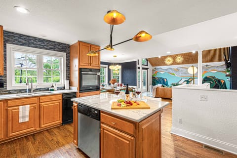 Savor culinary moments in this open, sunlit kitchen—perfect for gathering around the island with a glass of wine and good company.