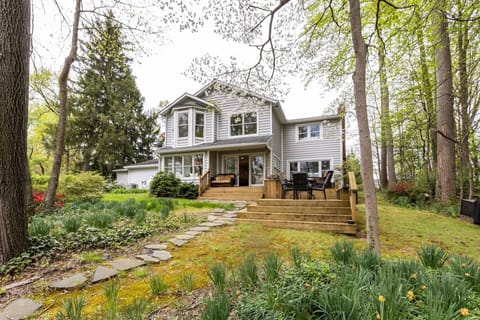 The expansive backyard and deck is a beautiful view when walking up from the private pier at the home's riverfront.