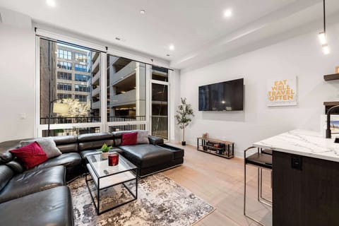 Sunlit living room framed by floor-to-ceiling windows for easy lounging.