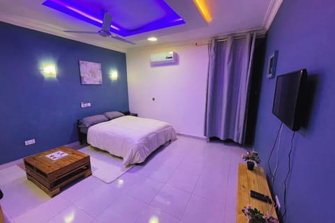 Cozy bedroom with single bed, air-conditioning, coffee table, and cable TV