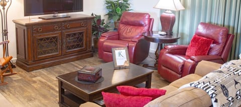 Living room with Roku TV, 2 recliners, 1 sofa, 1 rocking chair