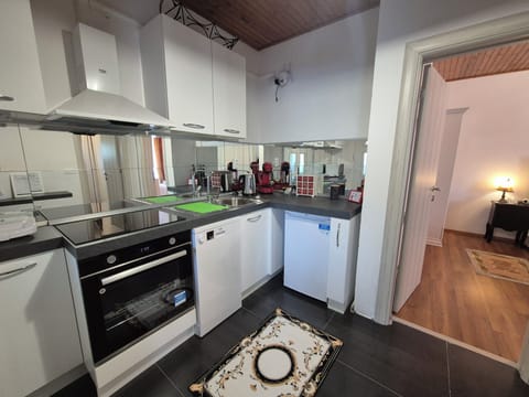 Fridge with freezer compartment, coffee machine, ceramic stove, oven, kettle.