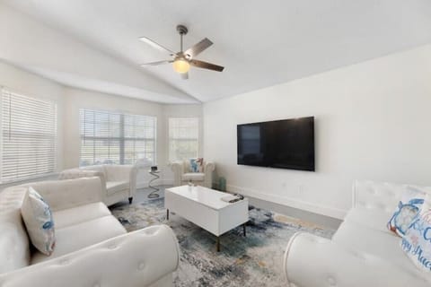 Comfortable spacious living room in Navarre with 75" HDTV, local art