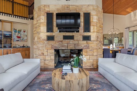 Living Room - Stone and wood finishes with dual fireplaces