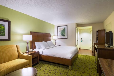 Unwind in a plush bed with warm, restful lighting.