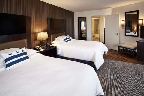 Unwind on crisp linens in a spacious double-queen room.