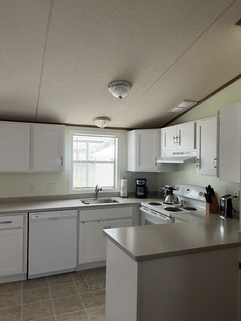 Full size kitchen with fridge, DW, utensils, basic condiments