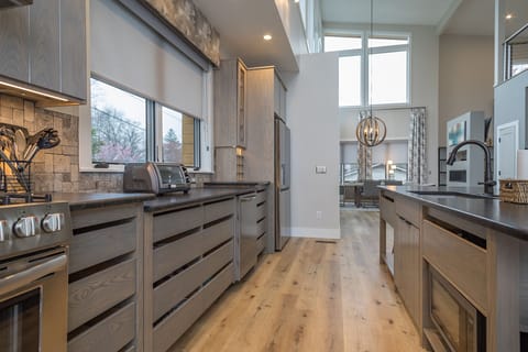 Well-equipped kitchen with island seating for 6, modern appliances, and drip-style coffee maker