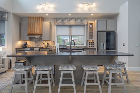 Well-equipped kitchen with island seating for 6, modern appliances, and drip-style coffee maker