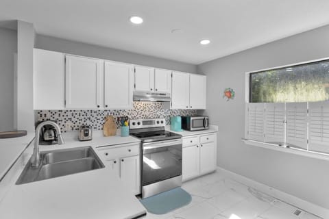 Fully equipped kitchen with all stainless steel appliances.