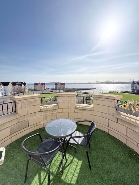 Private balcony with seating and stunning coastal views — the perfect spot for morning coffee or evening drinks