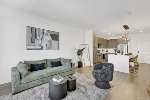 An elegant living area in Downtown Birmingham that blends modern design, natural light, and cozy touches for the perfect stay.