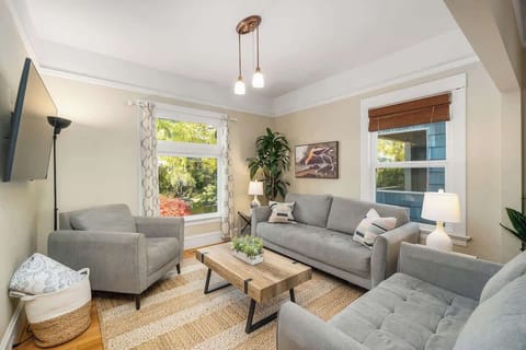 Living room with sofa seating and front windows.