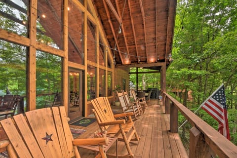 Large covered deck for entertaining, dining, relaxing in a rocking chair or lounging by the fire table with incredible views of the lake and mountains