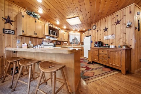 Charming kitchen setup with countertop and three chic chairs, perfect for a family meal