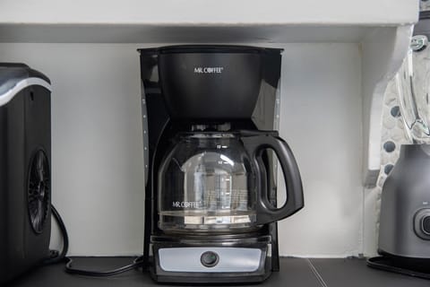 Fully stocked kitchen with all the essentials—coffee maker, cookware, blender, and more—perfect for cooking and dining together!
