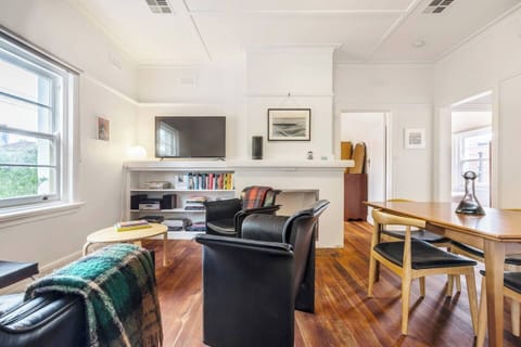 The living room adjoins the dining area, creating an effortless social flow. Enjoy relaxing together in the comfort of air-conditioning and central heating for cooler months. 
