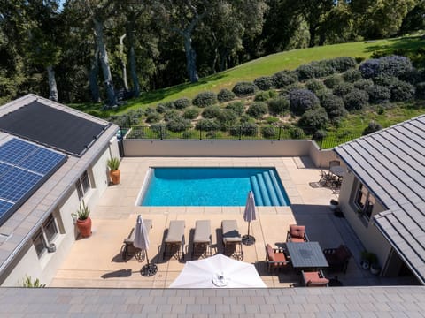 This private poolside sanctuary offers a resort-style experience, featuring a crystal-clear lap pool and a sun-drenched terrace. With premium loungers, an elegant dining set, and a cozy fire pit, it is the ultimate retreat for alfresco relaxation.