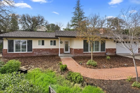 A welcoming entrance framed by greenery and quiet countryside charm.