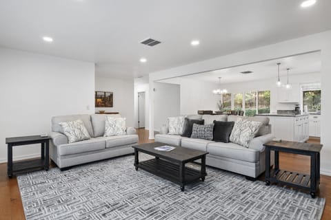 From the plush grey sofas to the chef’s kitchen, this bright, interconnected space is designed for modern living and entertaining.