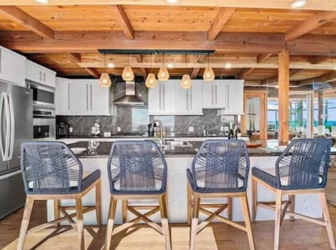 Mornings made better at this 4-chair island counter—perfect for a quick breakfast or a relaxing start to the day. The oversized kitchen, with its sleek finish and warm lighting, makes every meal feel special.