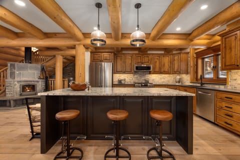 Kitchen with oversized island and seating for three.