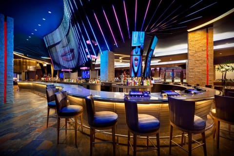 Sip handcrafted cocktails under dazzling lights at the signature bar.