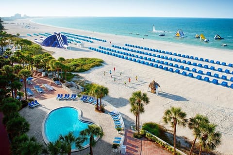 Dive into sparkling pool days steps from soft sands.