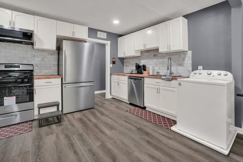 Kitchen with dishwasher, stove/oven, microwave, and washing machine.
