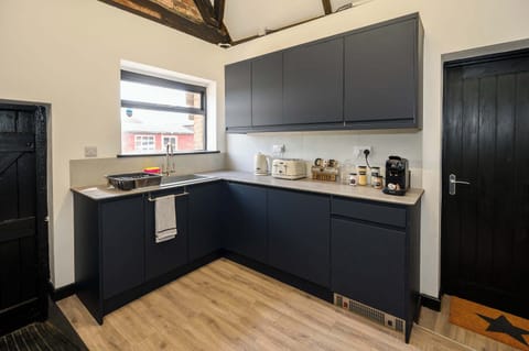 You'll find a kettle, toaster, microwave, double oven, electric hob, and washing machine